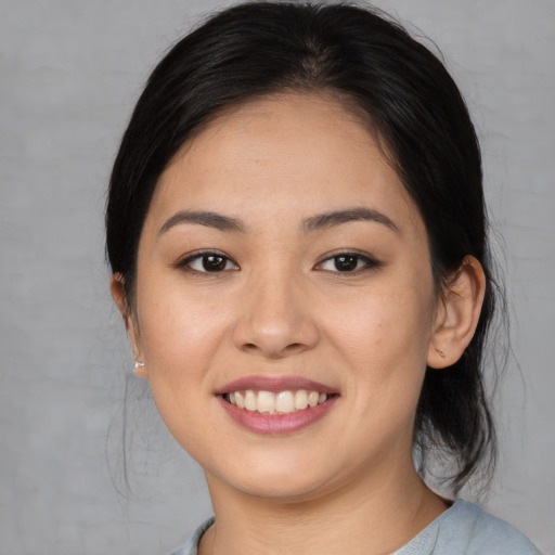 Joyful asian young-adult female with medium  brown hair and brown eyes