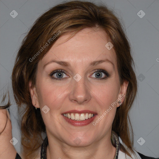 Joyful white adult female with medium  brown hair and blue eyes