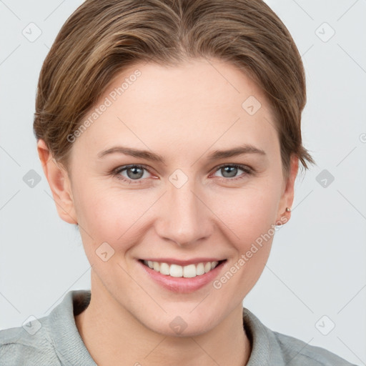 Joyful white young-adult female with short  brown hair and grey eyes