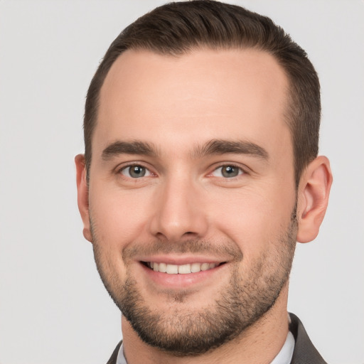 Joyful white young-adult male with short  brown hair and brown eyes