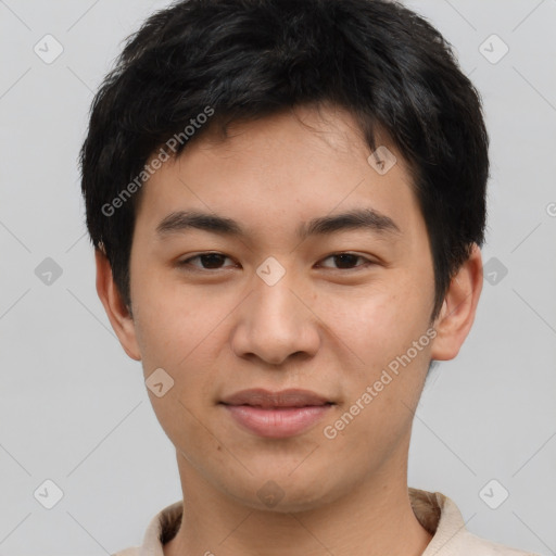 Joyful asian young-adult male with short  brown hair and brown eyes