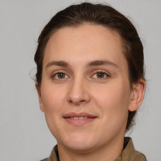 Joyful white young-adult female with medium  brown hair and brown eyes