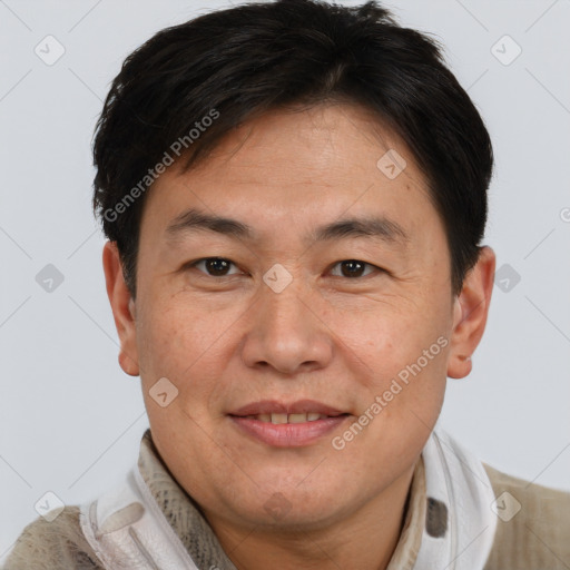 Joyful asian adult male with short  brown hair and brown eyes