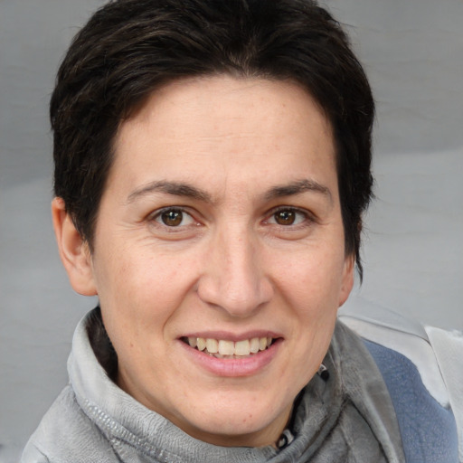 Joyful white adult female with medium  brown hair and brown eyes