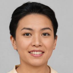 Joyful asian young-adult female with short  brown hair and brown eyes