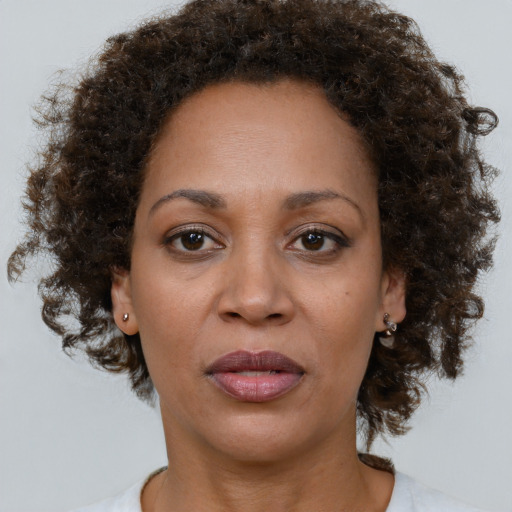 Joyful black adult female with short  brown hair and brown eyes