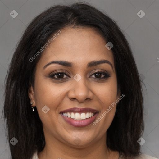 Joyful black young-adult female with long  brown hair and brown eyes