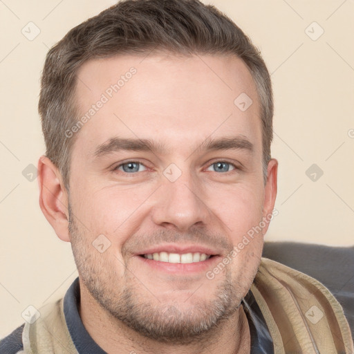 Joyful white young-adult male with short  brown hair and grey eyes