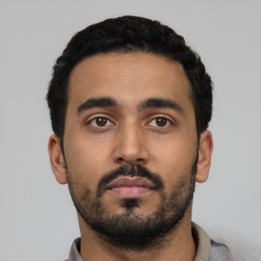 Neutral latino young-adult male with short  black hair and brown eyes