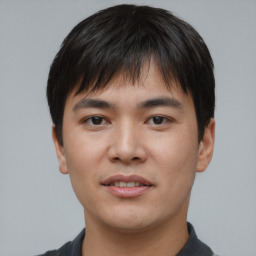 Joyful asian young-adult male with short  brown hair and brown eyes