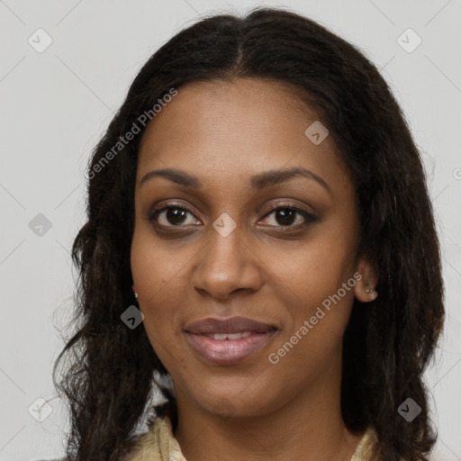 Joyful black young-adult female with long  brown hair and brown eyes