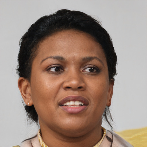 Joyful black young-adult female with short  brown hair and brown eyes