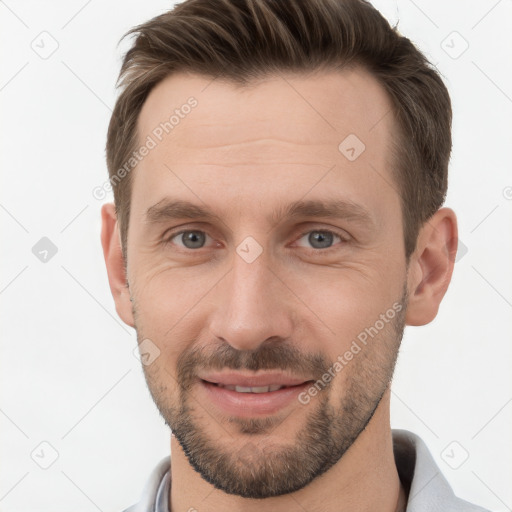 Joyful white young-adult male with short  brown hair and grey eyes