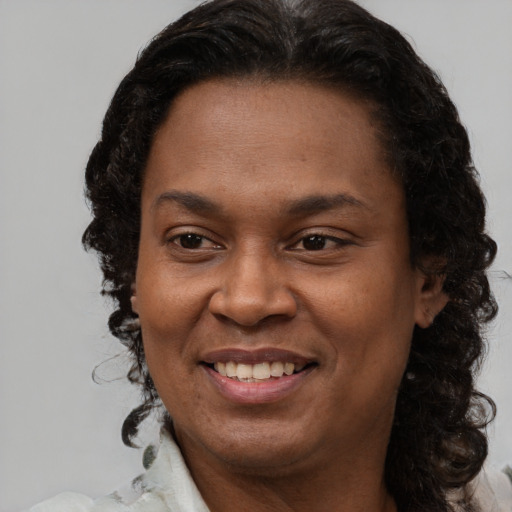 Joyful latino adult female with medium  brown hair and brown eyes