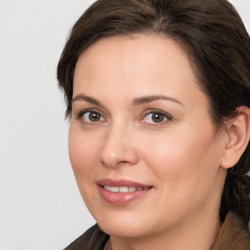 Joyful white adult female with medium  brown hair and brown eyes