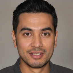 Joyful white young-adult male with short  black hair and brown eyes