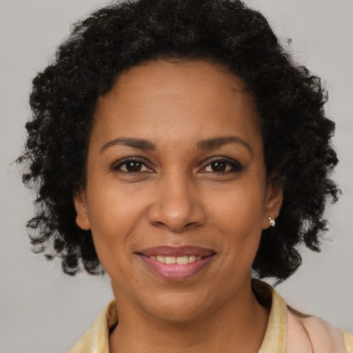 Joyful black adult female with short  brown hair and brown eyes