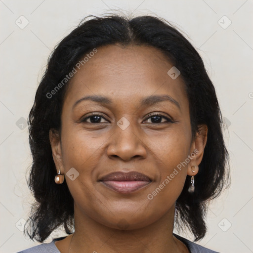 Joyful black adult female with medium  brown hair and brown eyes