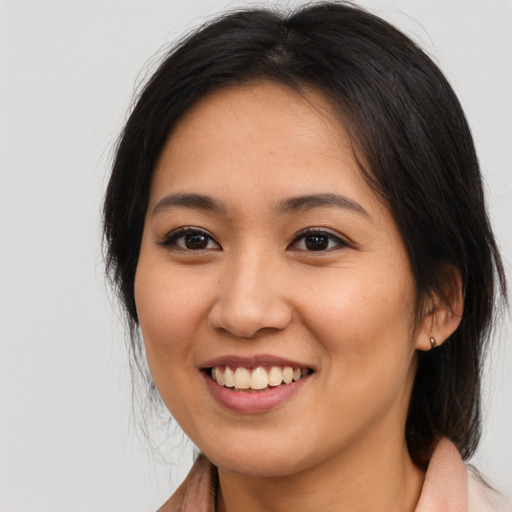 Joyful asian young-adult female with medium  brown hair and brown eyes