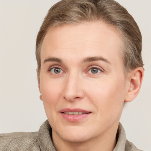 Joyful white adult female with short  brown hair and grey eyes