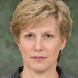 Joyful white adult female with medium  brown hair and grey eyes