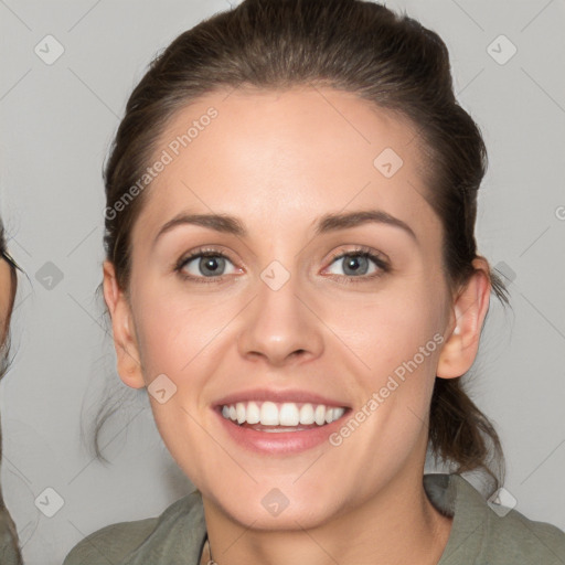 Joyful white young-adult female with medium  brown hair and grey eyes