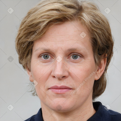 Joyful white adult female with medium  brown hair and blue eyes