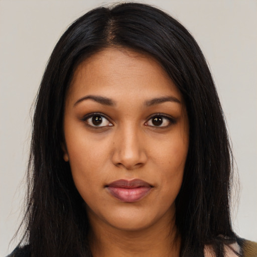 Joyful latino young-adult female with long  black hair and brown eyes