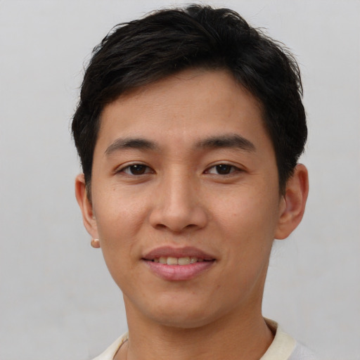 Joyful asian young-adult male with short  brown hair and brown eyes