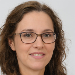 Joyful white adult female with long  brown hair and brown eyes