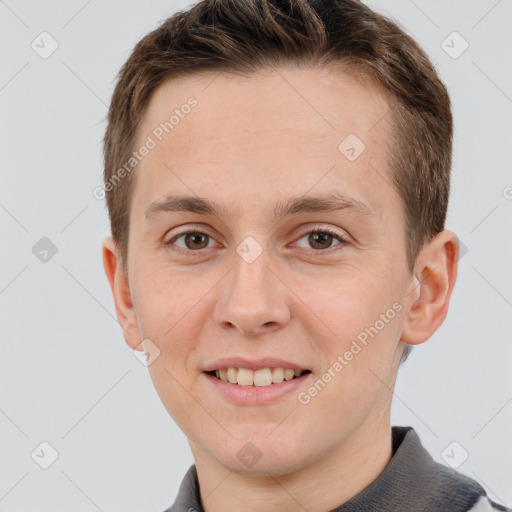 Joyful white young-adult male with short  brown hair and grey eyes