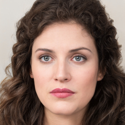 Joyful white young-adult female with long  brown hair and green eyes