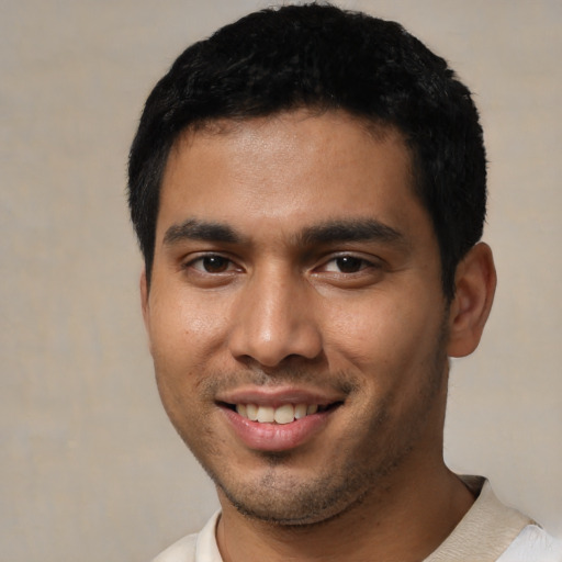 Joyful asian young-adult male with short  black hair and brown eyes