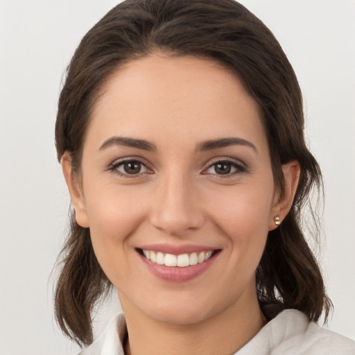 Joyful white young-adult female with medium  brown hair and brown eyes