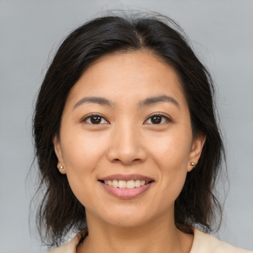 Joyful asian young-adult female with medium  brown hair and brown eyes