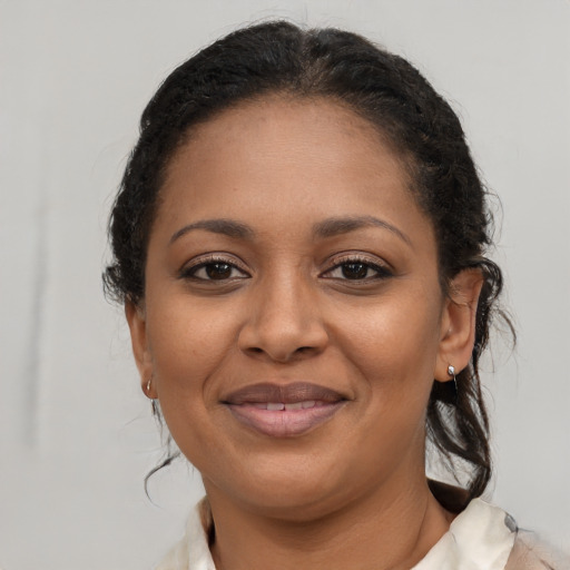 Joyful black young-adult female with medium  brown hair and brown eyes