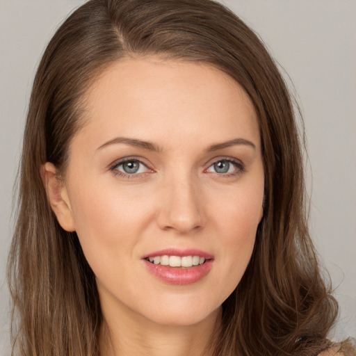 Joyful white young-adult female with long  brown hair and brown eyes