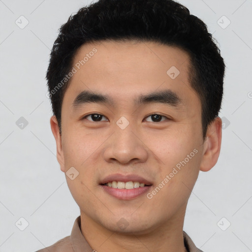 Joyful asian young-adult male with short  black hair and brown eyes