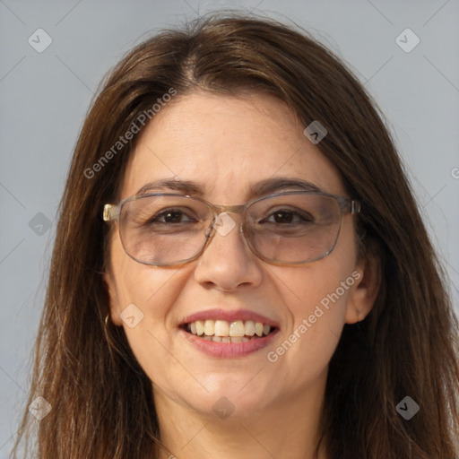 Joyful white adult female with long  brown hair and brown eyes