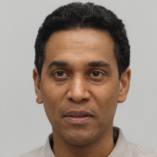 Joyful latino adult male with short  black hair and brown eyes