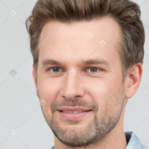 Joyful white adult male with short  brown hair and brown eyes