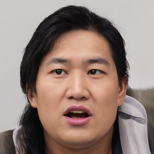 Joyful asian young-adult male with medium  black hair and brown eyes