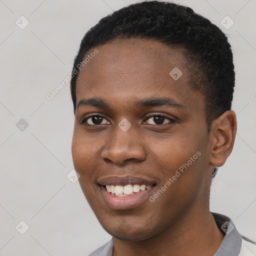 Joyful black young-adult male with short  black hair and brown eyes