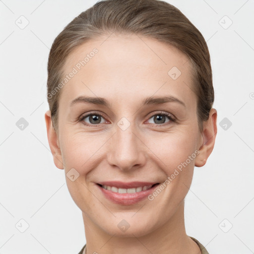 Joyful white young-adult female with short  brown hair and grey eyes