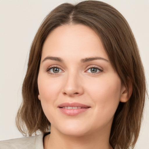 Joyful white young-adult female with medium  brown hair and green eyes