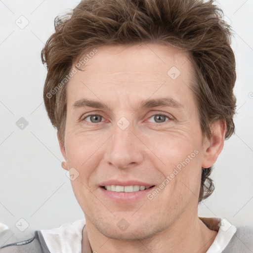 Joyful white adult male with short  brown hair and grey eyes