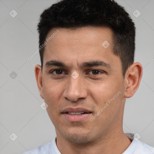 Joyful white young-adult male with short  black hair and brown eyes