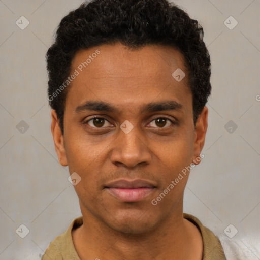 Joyful black young-adult male with short  black hair and brown eyes