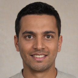 Joyful white young-adult male with short  black hair and brown eyes