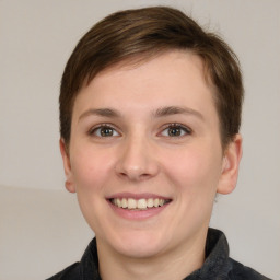 Joyful white young-adult female with short  brown hair and grey eyes